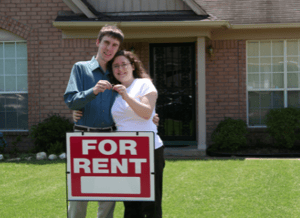 Couple standing in front of a house they're going to rent.